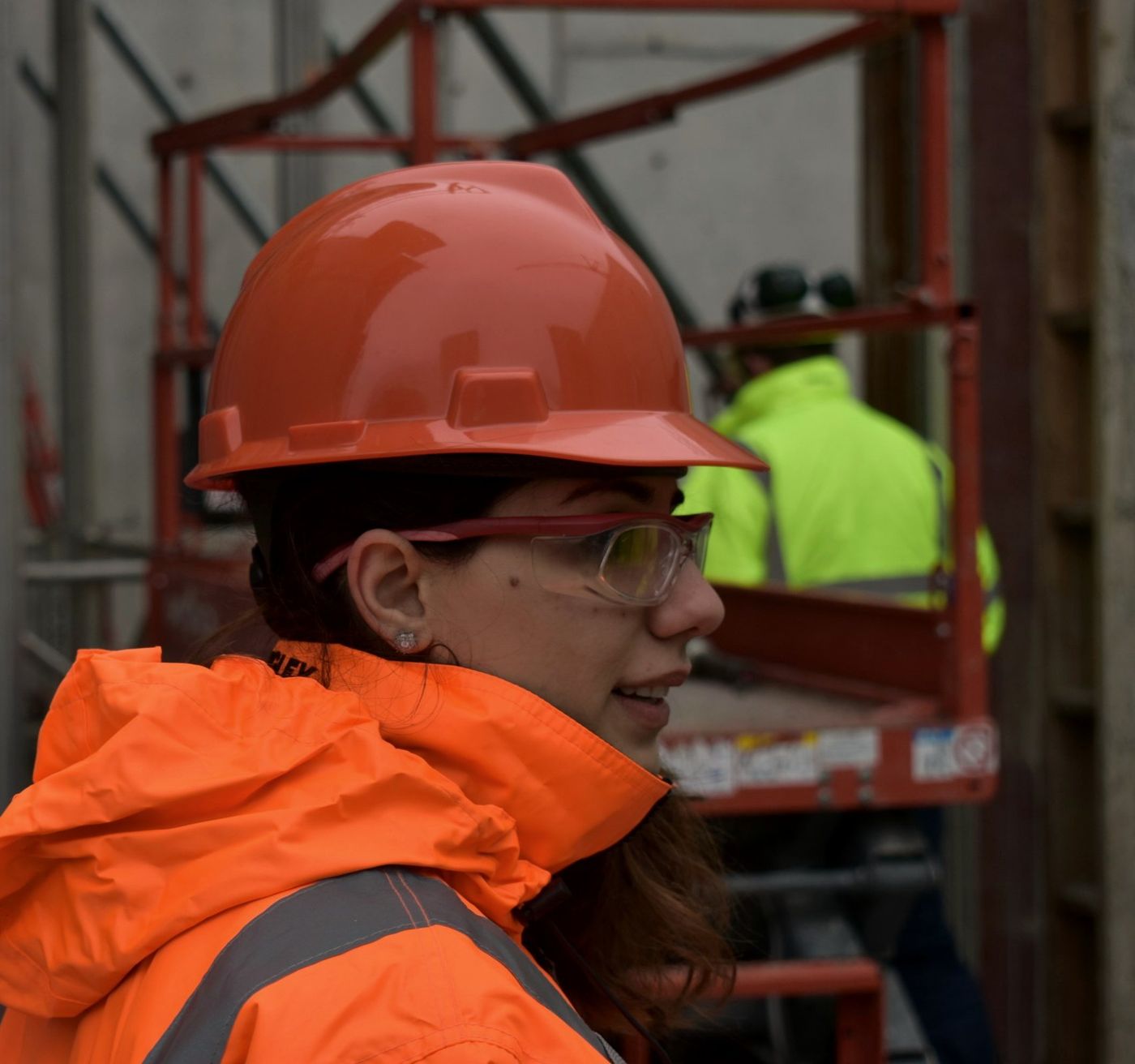 Site worker in a hard hat, safety glasses and hi-vis jacket